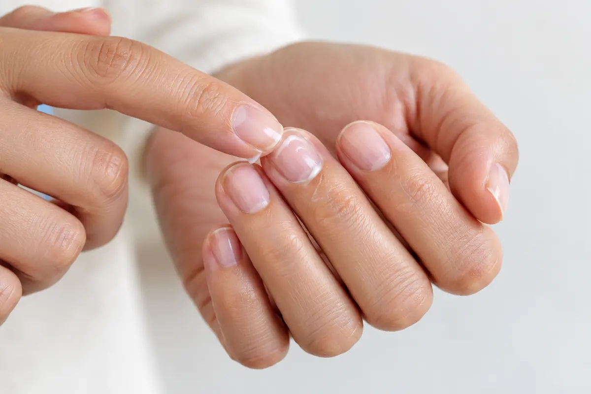 A small amount of moisturizer rubbed around natural nails